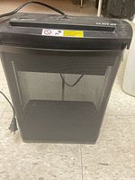 Front view of black electric paper shredder with mesh bin and power cord