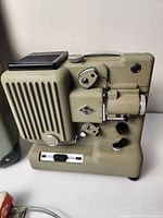 Front angle of Eumig P8 projector showing lens, film transport, control knobs, and model badge