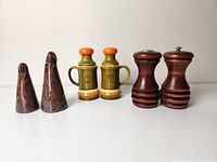 Three pairs of mid century salt and pepper shakers including ceramic and wooden models.