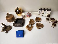 Overview of all items showing various ashtrays, ceramics, and dollhouse furniture