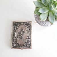 Front view showing embossed puppet figure and floral border