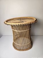 Front view of the vintage rattan side table showing top surface and lattice sides.