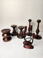 Photo showing all six wooden candle sticks together with a mix of styles and heights on a white background.