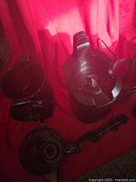 Multiple interchangeable parts of the Amzchef juicer set arranged against a red background with the lid, feed chute and pulp container visible