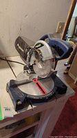 Full view of MasterCraft compound mitre saw showing Blade guard, handle, base and power cord.