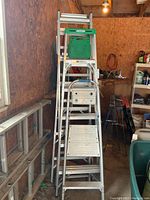 Overview of all three ladders stacked in garage