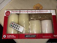 Boxed 9-piece Ashland flameless LED Christmas candle set with remote control visible through packaging window.