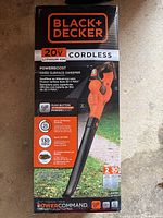 Photo of the product box showing the Black & Decker 20V Max cordless leaf blower with battery and charger. Box details specs like power boost, battery runtime, and air speed.