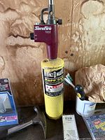 Photo of Surefire T655 blow torch attached to yellow Brenzomatic MAPP gas cylinder showing detailed labels and condition.