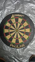 Photo of the round Accudart Pro-Line dart board showing the face and branding.