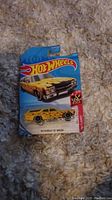 Photo of yellow Hot Wheels 70 Chevrolet 55 Wagon diecast car in original blue packaging.