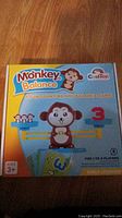 Box of Monkey Balance children's counting and balance game showing colorful graphics with monkey character, number cards, and balance scales.