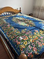 Full view of Italian vintage bed cover spread on bed, showcasing main floral design and edges.