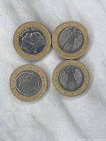 Back sides of 4 Greece 1 Euro coins showing different Greek designs and dates