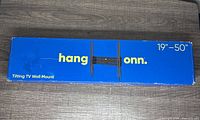 Box of Hang onn. Tilting TV Wall Mount for 19-50 inch TVs, blue box with white and yellow lettering.