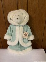 Front view of Boyds Bear Larissa Sparkle wearing light blue coat with white fur trim and original retail tag.