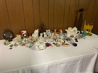 Full view of collection spread on table showing varied cat figurines and decorative pieces