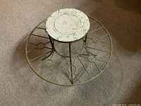 Closer view of the top circular platform and inner structure of the metal display stand