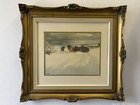 Full view of the framed art showing the winter landscape scene of horses and a man in the snow with ornate gold frame.