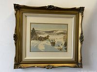 Full view of the antique framed winter landscape print showing the ornate gold frame with floral corners.