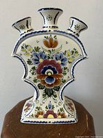 Front view of the tri-spout tulip vase showing central floral pattern and three flared spouts.