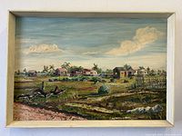 Full view of landscape painting with rural houses, greenery, and clouds in a frame.
