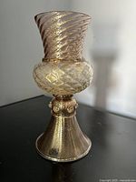 Front view showing spiral flared rim, diamond-patterned bulb, and flared base