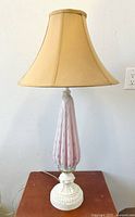 Full view of lamp on wooden table against white wall, lamp off