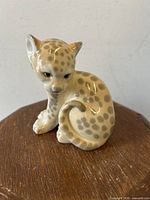 Front angle view of the leopard cub figurine showing detailed face and spotted pattern