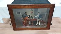 Frontal image showing the entire framed oil painting depicting a colonial tavern scene with four men and a dog