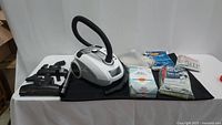 Full lot including vacuum cleaner, attachments and vacuum bags