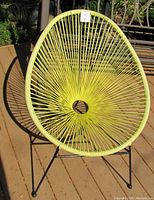 Front and top view of a yellow Acapulco chair showing woven vinyl cords and black metal base