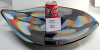 Top view of the heavy glass center bowl showing colorful slag glass pattern over a black glass base with a Coca-Cola can for scale.