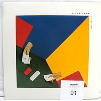 Photo of the original album cover sleeve featuring abstract colorful design with hands holding playing cards, showing front cover condition.