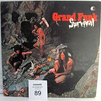 Front textured cover jacket of Grand Funk Railroad's Survival album with cave setting and band members.
