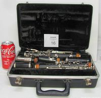 Open case with disassembled Selmer Signet clarinet visible inside next to a soda can for scale.