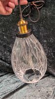 Photo of the black and gold glass pendant light showing teardrop shape and twisted glass pattern