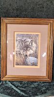 Front view of the framed wolf print showing the detailed wolf image and wooden frame.