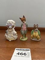 Three Beatrix Potter Beswick porcelain figurines grouped: Lady Mouse, Foxy Whiskered Gentleman, Samuel Whiskers.