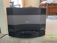 Front view of main unit showing curved speaker grille and overall shape