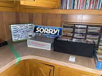 Photo of board games Sorry, Win Lose or Draw and a box with Power Napalm puzzle