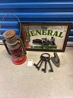 Image showing an antique Beacon lantern, the railroad mirror sign with 'The General' U.S. Railroad Locomotive, four iron keys, and a small iron weight or flat iron.