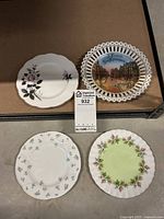 Four collector plates: three Royal Albert English china plates with floral designs and one Bavaria plate with scenic design and pierced edges