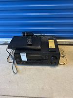 Photo showing both the Sony DVD player and Onkyo receiver stacked, with their remotes on top.