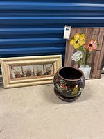 Lot with two framed flower prints and one painted ceramic flower pot with tray.