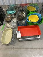 Photo showing Anita mechanical food scale with red tray, assorted metal ring molds, Cuisinart mixing bowls in multiple colors, and other baking accessories.