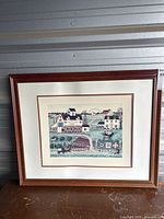 Overall view of the framed print showing the wooden frame, double matte, and complete artwork.