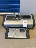 Full view of HP Photosmart 7760 photo printer showing front tray and display