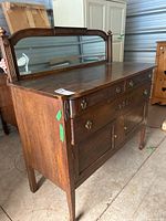 Front view of oak wood sideboard with mirror frame attached