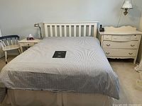 Full view of queen bed, nightstand, chair, dresser against wall showing color and condition